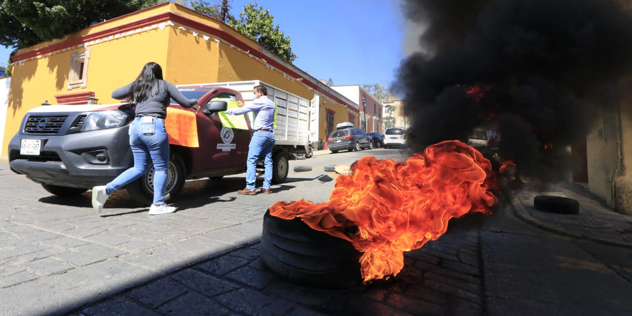 Con bloqueo y quema de llantas, exigen prestaciones trabajadores de confianza de Oaxaca de Juárez