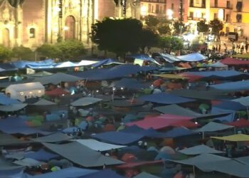 Un zócalo tapizado de hules de color, mecates y tendidos se observa hoy por la noche en la capital de la República.