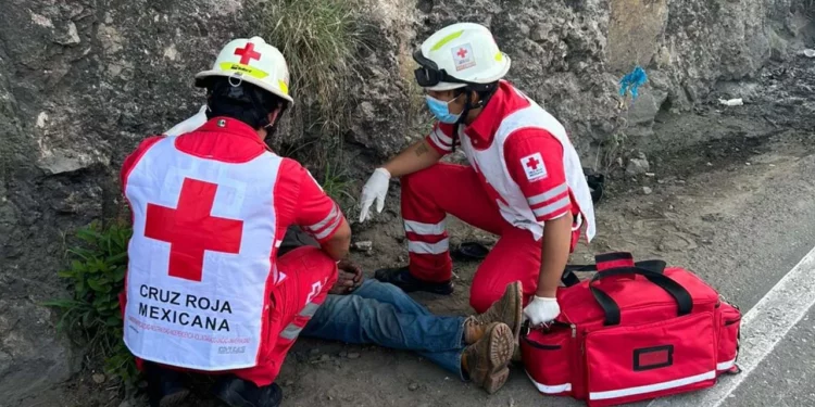 Paramédicos estabilizan sobre la carretera al Cerro del Fortín al motociclista de 62 años.